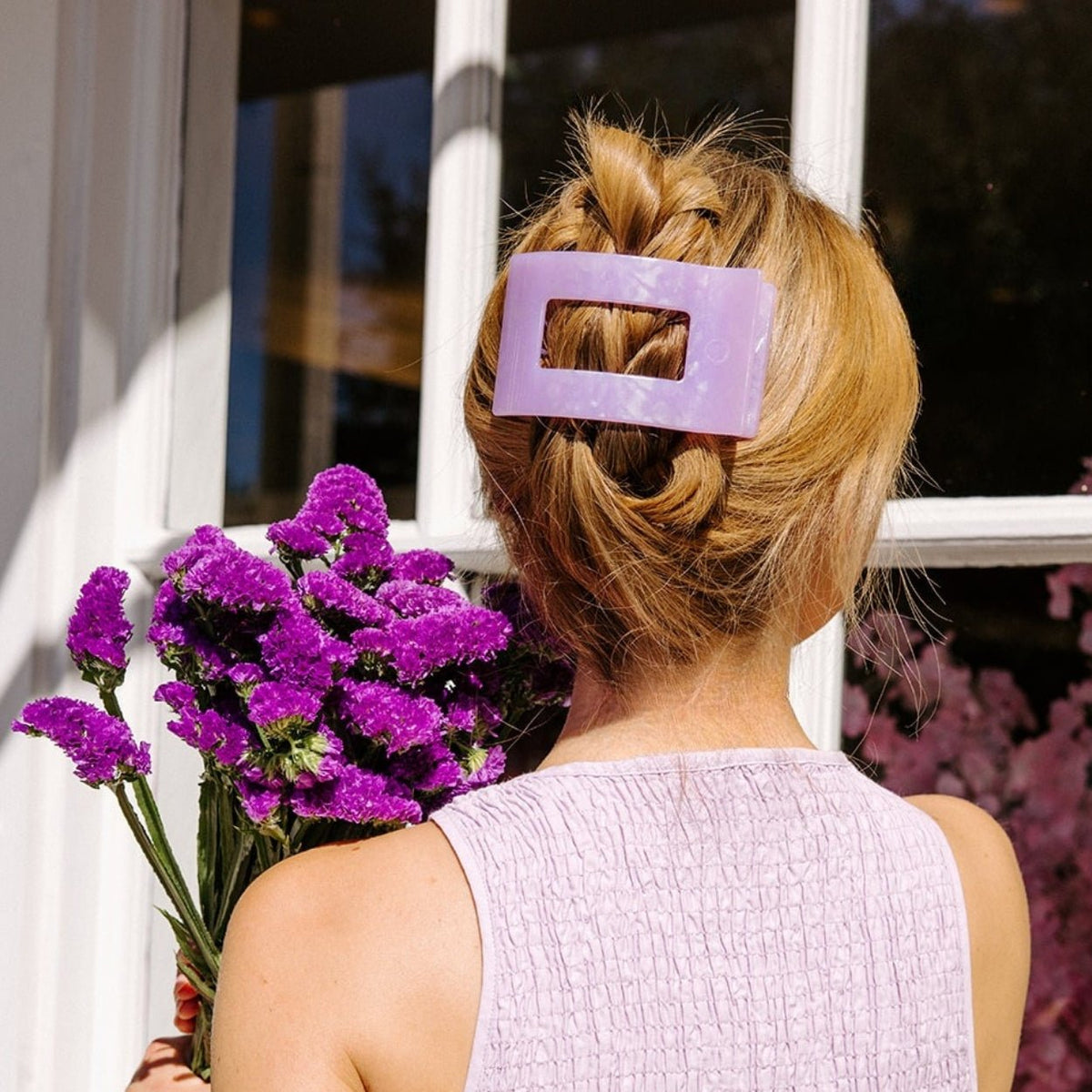 Lavender rectangle hair clip clipped to a bun hairstyle