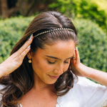 Platinum beaded headband on dark hair, thin silver bead band across forehead
