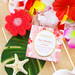 Red flower-shaped body wash sponge buffer with boxed product and tropical floral accents.