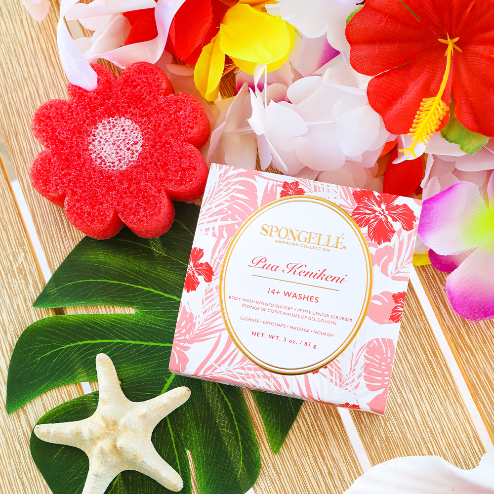 Red flower-shaped body wash sponge buffer with boxed product and tropical floral accents.