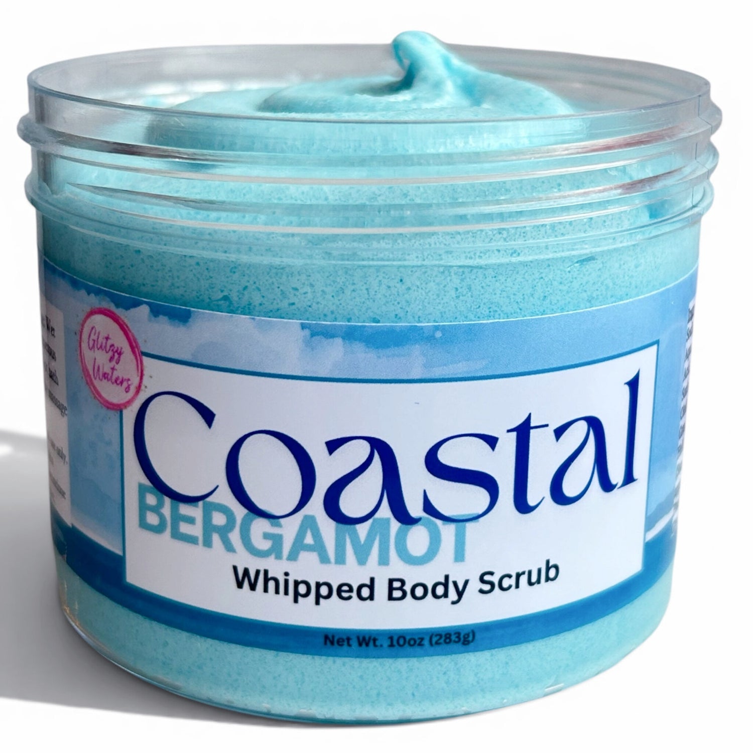 Sea-blue whipped body scrub in clear-lid jar, Bergamot label on front