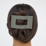 Sage green flat rectangle hair clip holding styled hair at the back