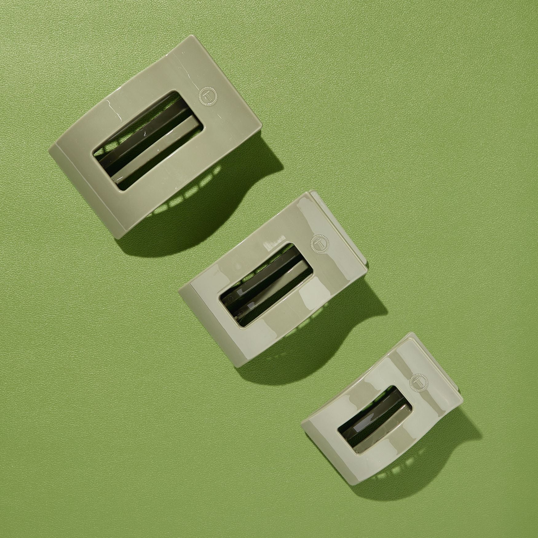 Set of large flat rectangle hair clips in sage green, three-pack view