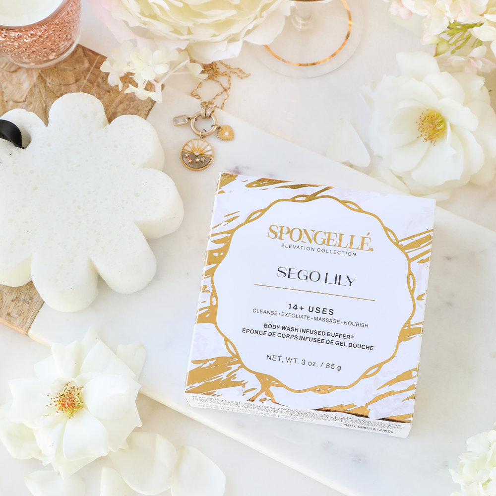 Spongelle boxed cleansing buffer with white flower-shaped exfoliating sponge