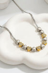 Two-tone beaded Y-necklace with silver links and gold-and-white heart teardrop charms
