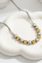 Two-tone beaded Y-necklace with silver links and gold-and-white heart teardrop charms