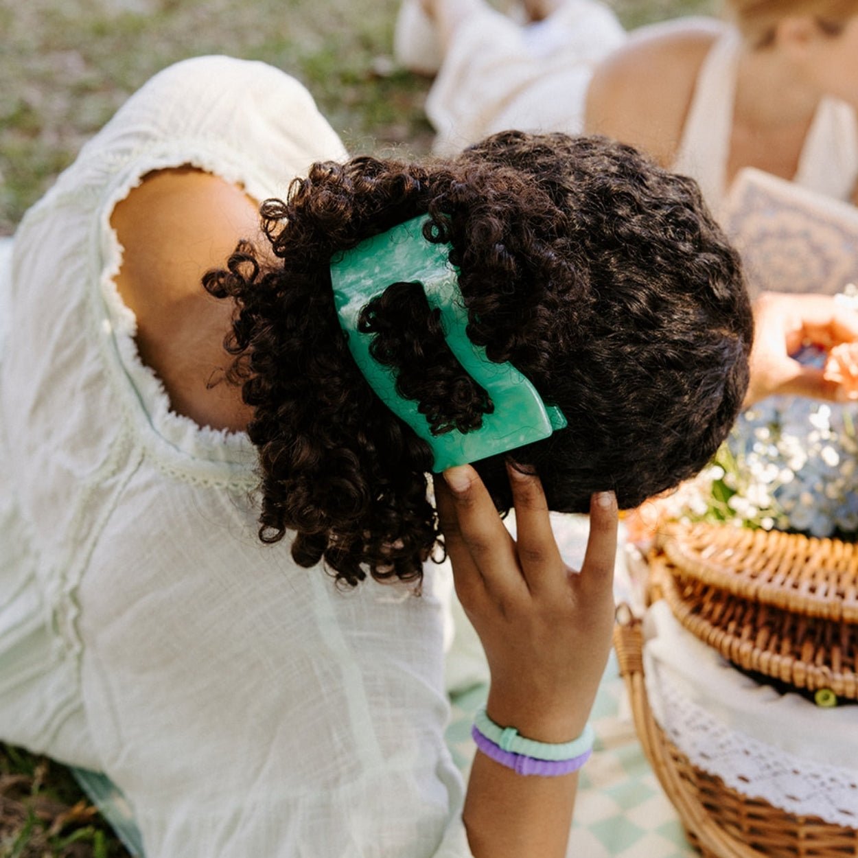 Large flat rectangle hair clip, translucent mint green on curly hair.