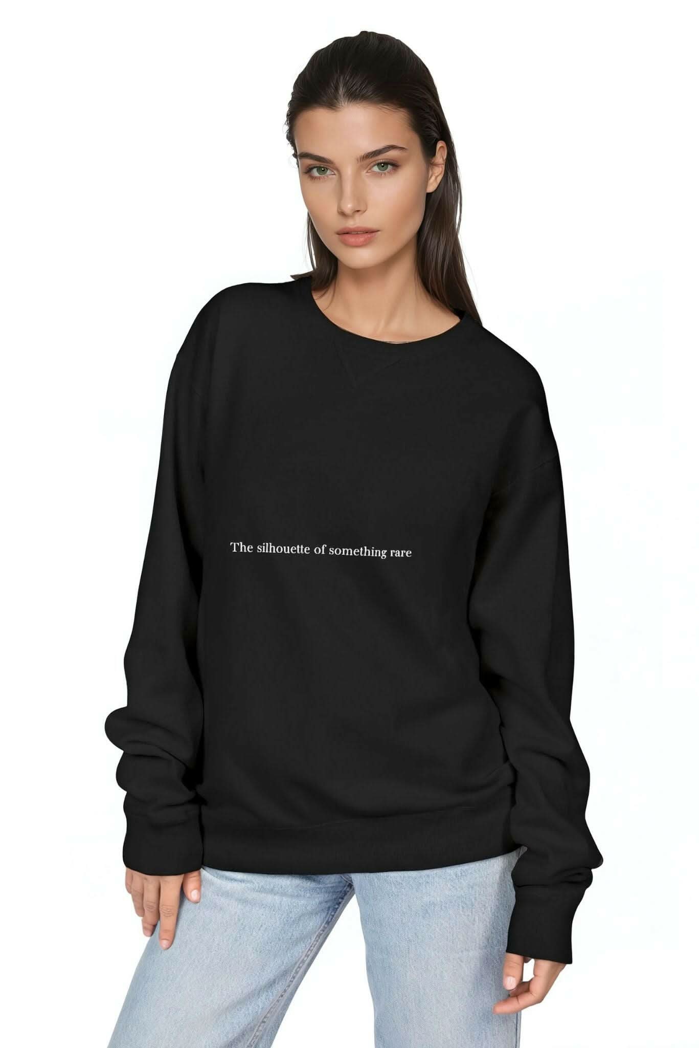 Black crewneck sweatshirt with long sleeves and ribbed cuffs, small chest slogan
