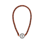 Beaded headband with orange-brown strands and a round white T charm centerpiece