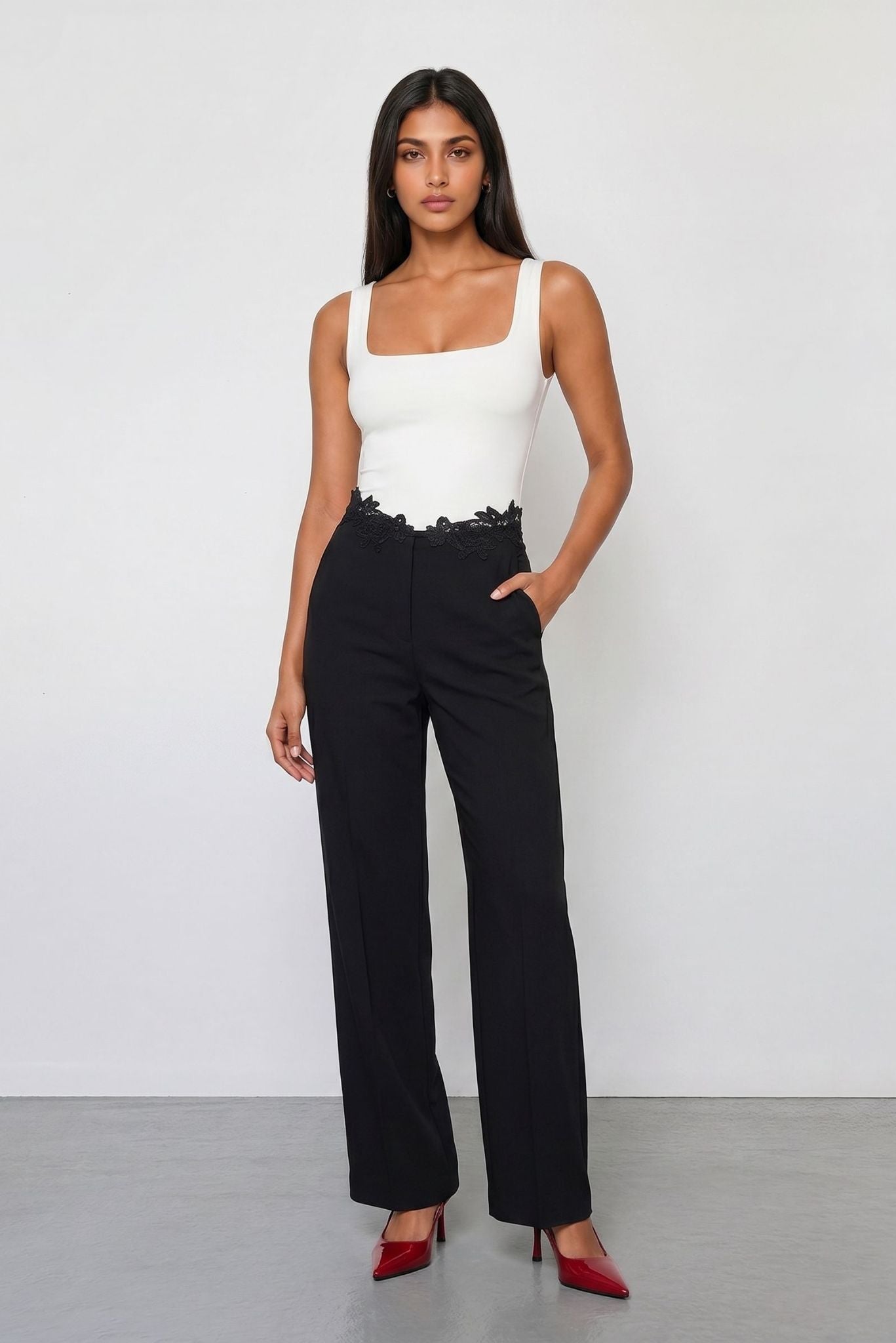 Contrast jumpsuit with square-neck white bodice and black wide-leg trousers with lace trim