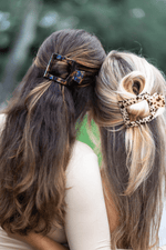 Medium tortoiseshell flat square hair clip holding hair side section