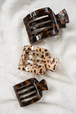 Leopard-print and tortoiseshell square flat hair clips, three clips shown