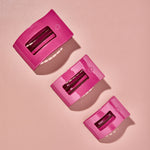 Set of three pink rectangle hair clips with slotted teeth